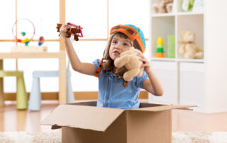 Kid child pilot flying a cardboard box in kid room