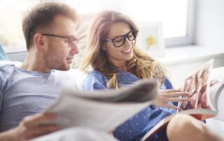 male and female reading magazines